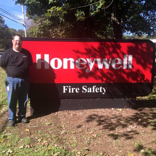 Employment Services Attendee in front of a Honeywell sign